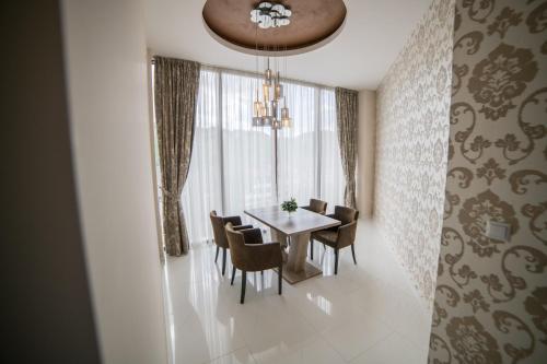 a dining room with a table and chairs at Hotel Urban in Bužim