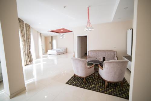 a living room with a table and two chairs at Hotel Urban in Bužim