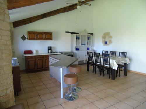 a kitchen and dining room with a table and chairs at Le Petit Moulin, Ste Soline in Sainte-Soline