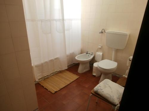 a bathroom with a toilet and a sink and a shower at Mar a Vista Family Apartment in Ericeira