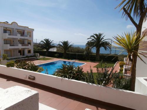 a view of the pool from the balcony of a building at Mar a Vista Family Apartment in Ericeira