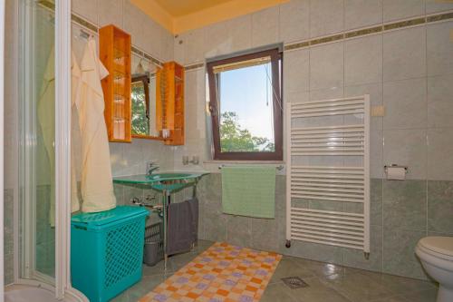 a bathroom with a shower and a toilet and a sink at Apartment Anai Rijeka in Rijeka