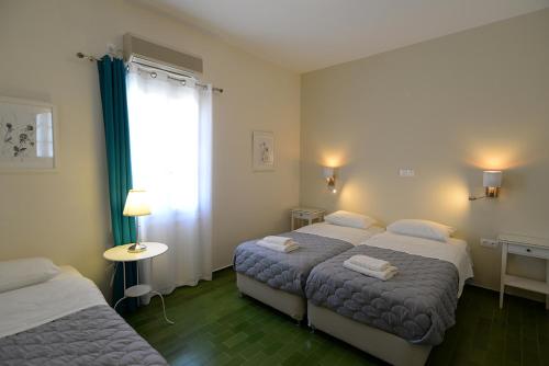 Ένα ή περισσότερα κρεβάτια σε δωμάτιο στο Βίλα Άνεσις
