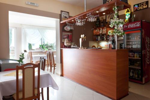 a restaurant with a counter with a table and a bar at Willa Rawia 2 in Rewal