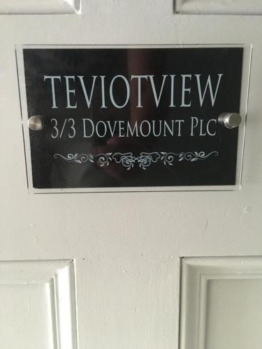 a sign on top of a door with the wordlevizons pile at Teviot View Holiday Let’s Hawick in Hawick