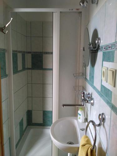 a bathroom with a tub and a sink and a shower at Penzion u sluníčka in Mikulov