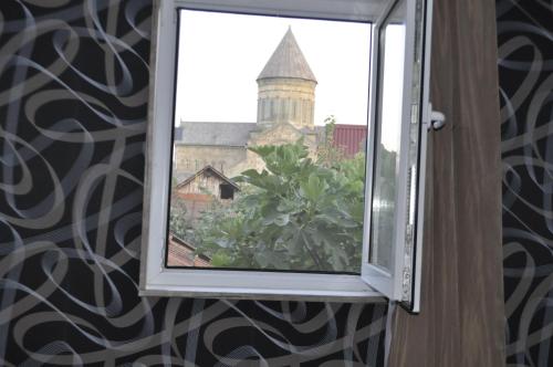 a window with a view of a church at Guesthouse Dariali in Mtskheta