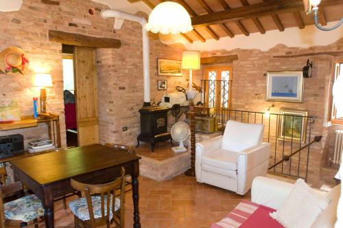 a living room with a table and chairs and a fireplace at B&B La Cappellania in Montegiorgio
