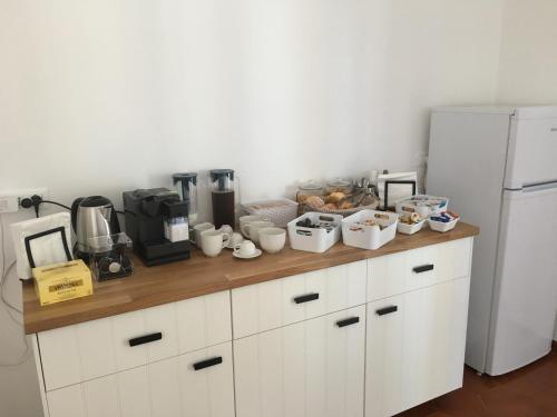 a kitchen counter with cups and other items on it at Villa Iavernaro in Pulsano