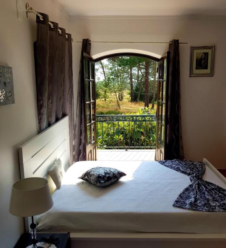 a bedroom with a bed and an open door at Lucas Residence in Nazaré