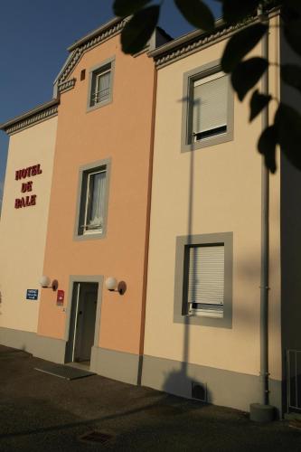 a building with a door on the side of it at Hôtel de Bâle in Bantzenheim