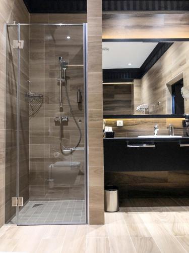 a bathroom with a shower and a toilet and a sink at ASTORIA Boutique Hotel in Bălţi