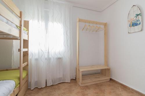 a bedroom with a bunk bed and a mirror at La casa azul,una casa en la ciudad. in Logroño