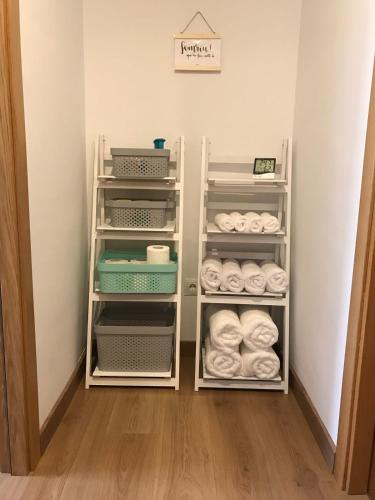 a closet with white shelves and towels at CAL PAU Guardiola de Berguedà in Guardiola de Berguedà