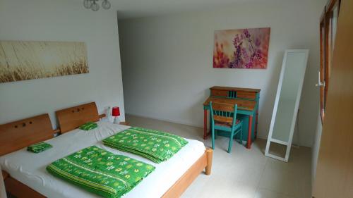 a small bedroom with a bed and a desk at Ferienwohnung Duttental in Tuttlingen