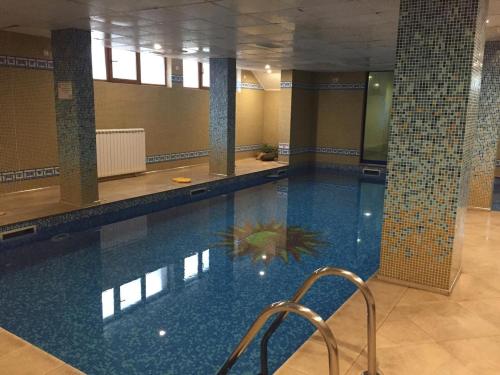 a large swimming pool in a building at Northstar Ski Apartment in Mountain Lake Hotel in Pamporovo