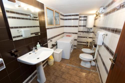 a bathroom with two toilets and a sink at Sobe pri Anici in Koper