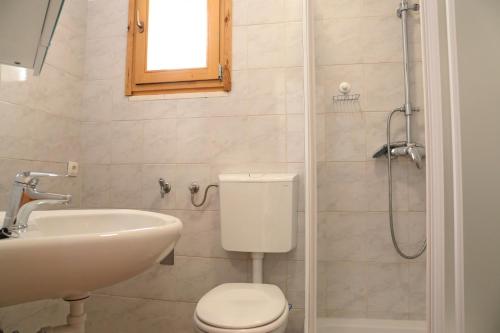 a bathroom with a toilet and a sink and a shower at Villa Korculaholidays in Zavalatica
