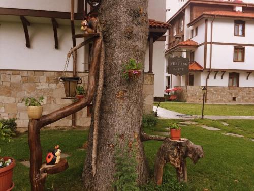 a statue of an elephant standing next to a tree at Northstar Ski Apartment in Mountain Lake Hotel in Pamporovo