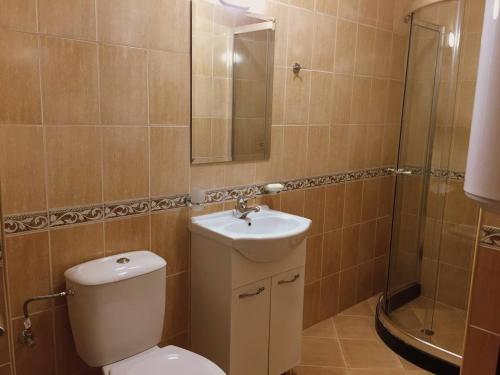 a bathroom with a toilet and a sink and a shower at Northstar Ski Apartment in Mountain Lake Hotel in Pamporovo