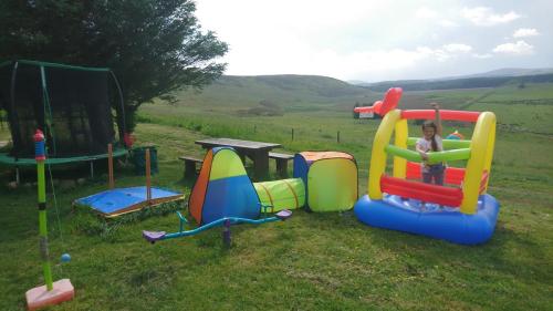 a young girl is playing on a playground at Scotland Paradise Relax Accommodation by Shooting Club Kirriemuir in Balintore
