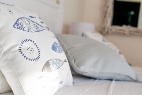a bed with two pillows on top of it at POSEA - Polignano Sea Suites in Polignano a Mare