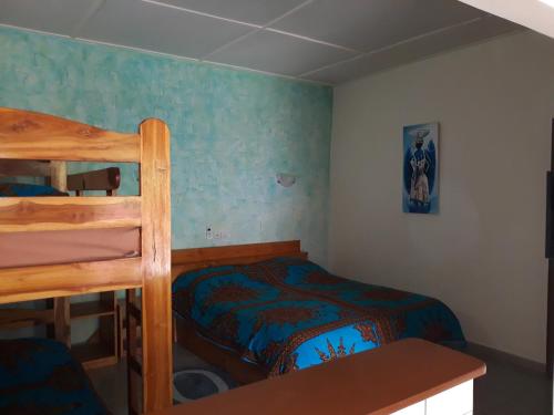 a bedroom with a bed and a bunk bed at Hotel Robinson Plage in Lomé