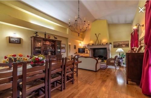 a living room with a dining table and a fireplace at The Forest House in Isernia