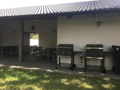 a patio with a table and chairs next to a building at Penzion U Hujňáků in Rohatec