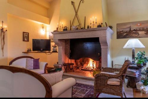 a living room with a fireplace with a fire place at The Forest House in Isernia