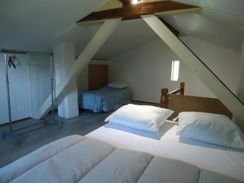 une chambre avec deux lits et un ventilateur de plafond dans l'établissement cottage pleine nature, à Wattwiller