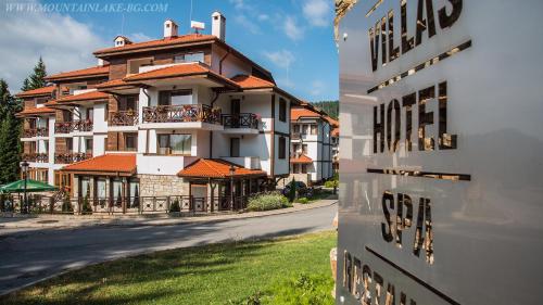 a large apartment building with balconies on a street at Northstar Ski Apartment in Mountain Lake Hotel in Pamporovo