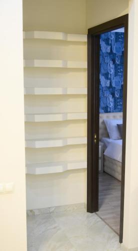 a room with a striped wall with a door at Metekhi Vista in Tbilisi City