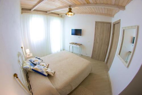 En eller flere senger på et rom på Capo Testa Vista Mare