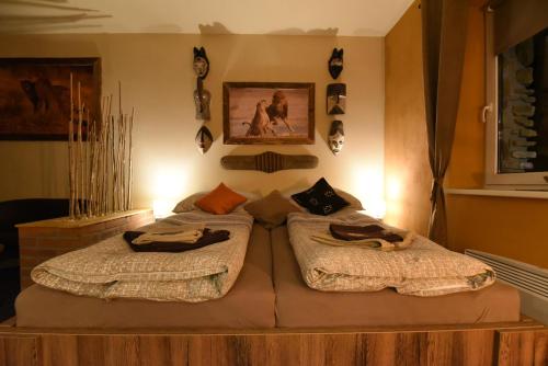 a bedroom with a bed with towels on it at Cheetah Holiday Club in Vizovice