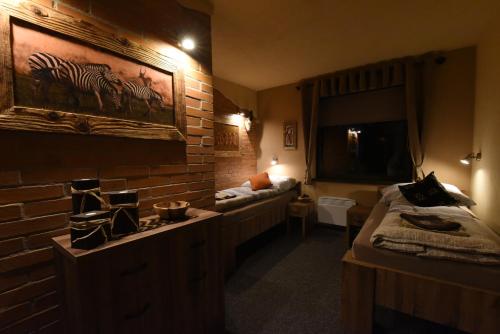 a room with two beds and a brick wall at Cheetah Holiday Club in Vizovice