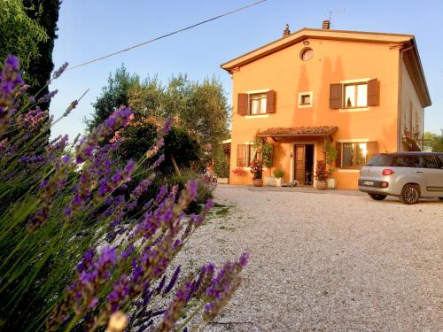 a house with purple flowers in front of it at Locanda della Lavanda in San Clemente