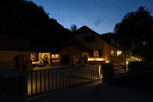 a house with a fence at night with lights at Cheetah Holiday Club in Vizovice