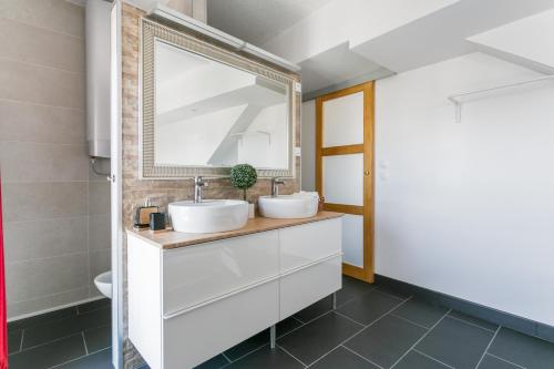 a bathroom with two sinks and a mirror at Luxury Penthouse in Naturiste; FKK, Nudist Village in Cap d'Agde