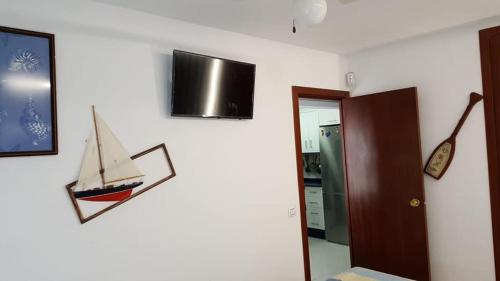 a wall with a picture of a boat on it at En Marina D'Or primera linea real in Oropesa del Mar
