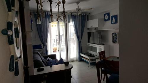 a living room with a couch and a table at En Marina D'Or primera linea real in Oropesa del Mar