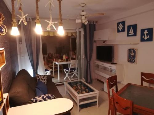 a living room with a couch and a table at En Marina D'Or primera linea real in Oropesa del Mar
