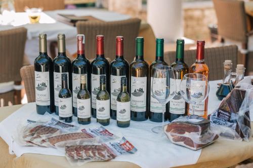 a bunch of bottles of wine sitting on a table at Villa Royal Apartments in Tivat