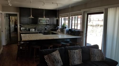 a kitchen with a couch and a counter top at Gondola Lodge & Tahoe Beach Club in South Lake Tahoe