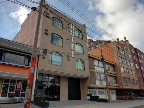 a brick building with a tower on top of it at Hotel Portal de los Andes in Bogotá