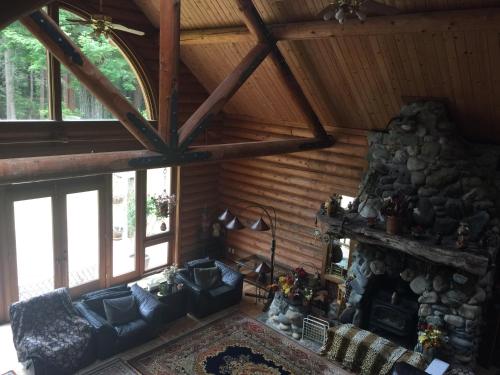 a living room with couches and a fireplace in a cabin at Redwood forest in Crescent City