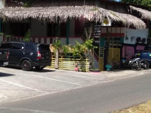 a black suv parked in front of a building at Dasi Guesthouse in Ende