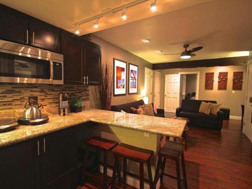 a kitchen and living room with a counter and chairs at Gondola Lodge in South Lake Tahoe