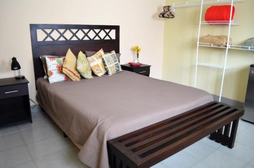 a bedroom with a large bed with many pillows at Casa Mesa in Guatemala