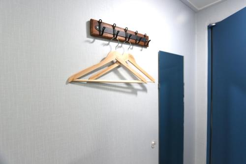a wooden hanger in a room with a door at HAH Guesthouse in Seoul